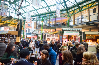 A snapshot showing the throngs of people and a variety of stalls at Borough Market, London